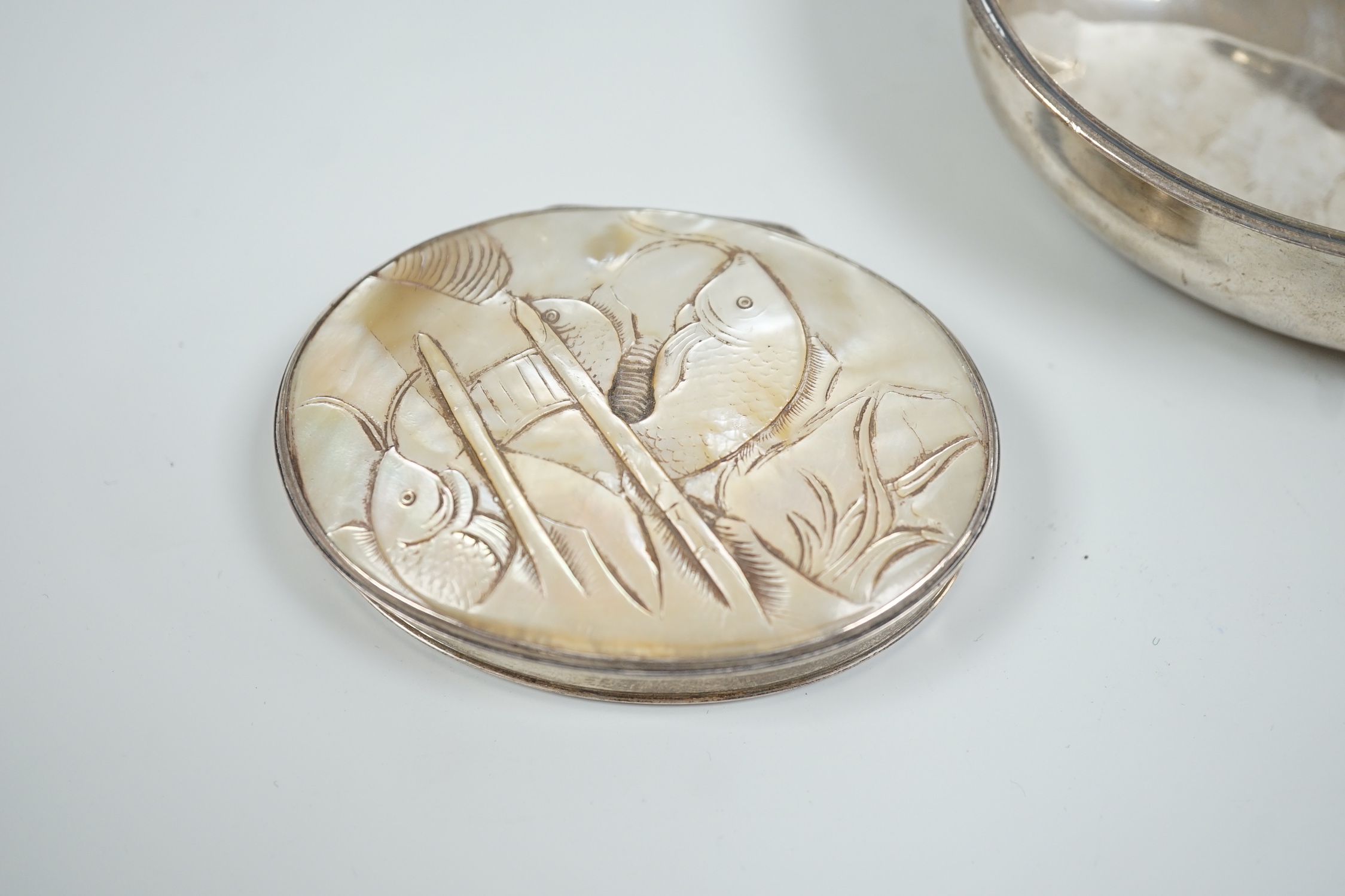 A late George III silver pap boat, London, 1817, 12.8cm, together with a 19th century white metal oval snuff, with inset mother of pearl cover, carved with fish, 8cm.